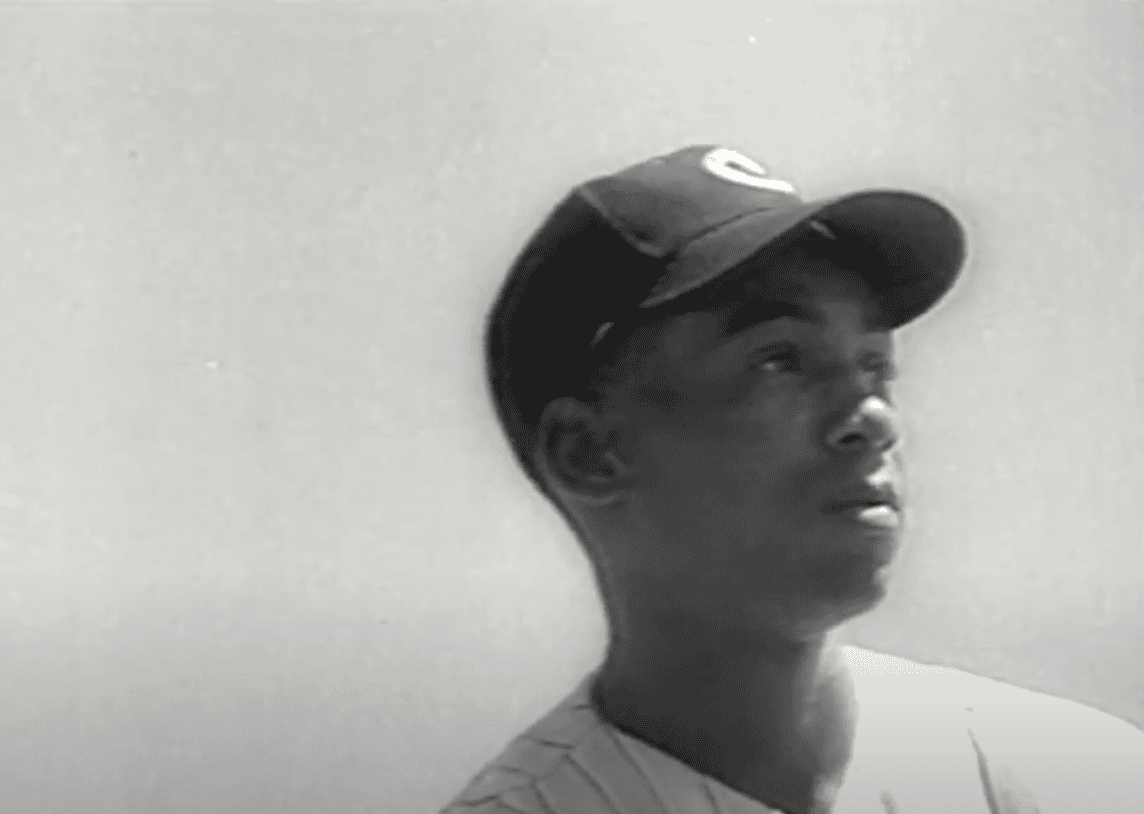 Image of Ernie Banks showcasing his legendary batting prowess in a clean power context.